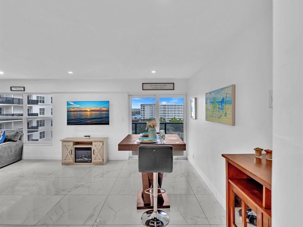 5100 Dupont Boulevard, Unit 8G Fort Lauderdale, FL 33308 - Photo 8 of 65 a work room with furniture a flat screen tv and a fireplace