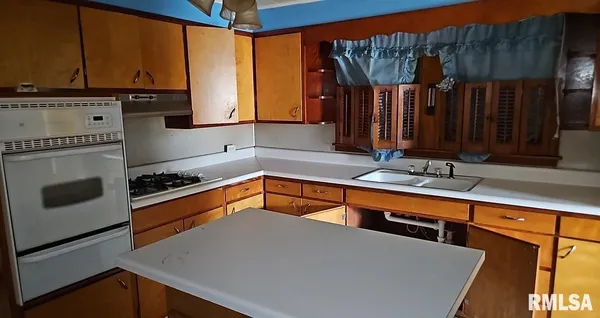 a kitchen with stainless steel appliances a sink stove and a refrigerator