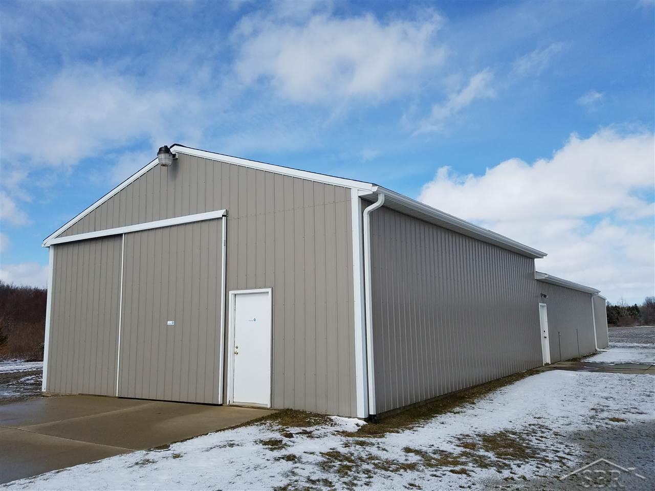 4580 West Gary Road Chesaning, MI 48616 - Photo 6 of 32 Cement floors, water and 100 amp electrical service, insulated workshop area, alarm system, cement approach. Separate driveway. One built in 1996 and addition added in 2005.