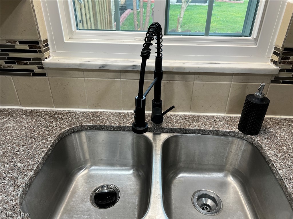 7475 Selwick Drive Parma, OH 44129 - Photo 11 of 29 Details with sink and tasteful backsplash