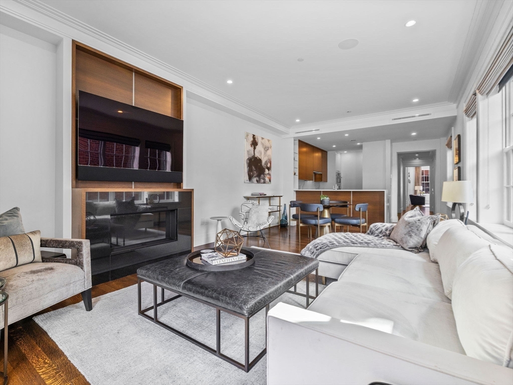 5 Joy Street, Unit 1 Boston, MA 02108 - Photo 12 of 32 a living room with furniture a fireplace and a flat screen tv