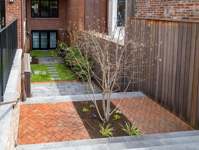 a backyard of a house with outdoor seating