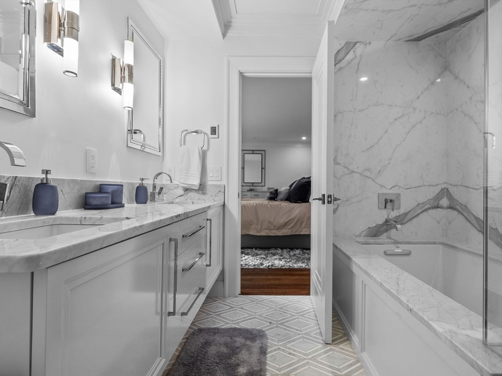 5 Joy Street, Unit 1 Boston, MA 02108 - Photo 22 of 32 a spacious bathroom with a granite countertop sink and a bathtub