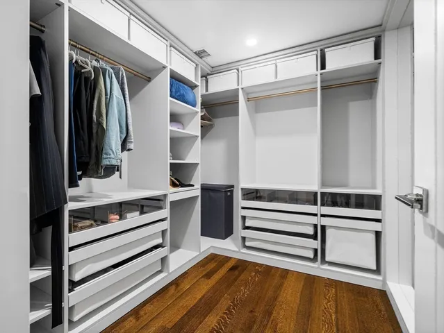a view of walk in closet with empty racks