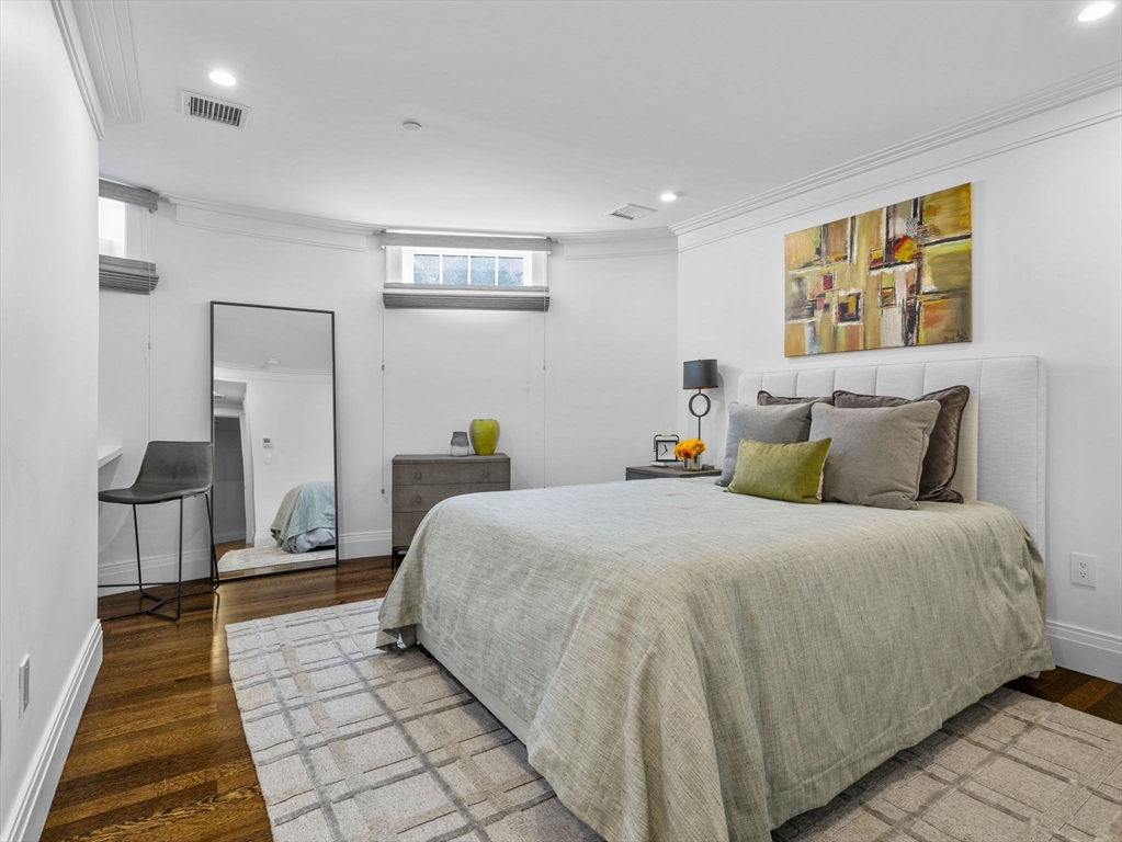 5 Joy Street, Unit 1 Boston, MA 02108 - Photo 26 of 32 a bedroom with a bed and wooden floor