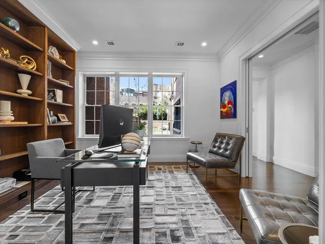a living room with furniture and a book shelf