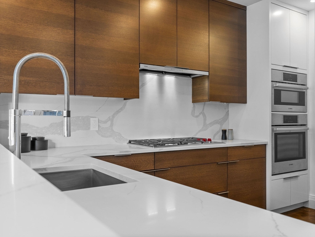 5 Joy Street, Unit 1 Boston, MA 02108 - Photo 8 of 32 a kitchen with a sink cabinets and stainless steel appliances