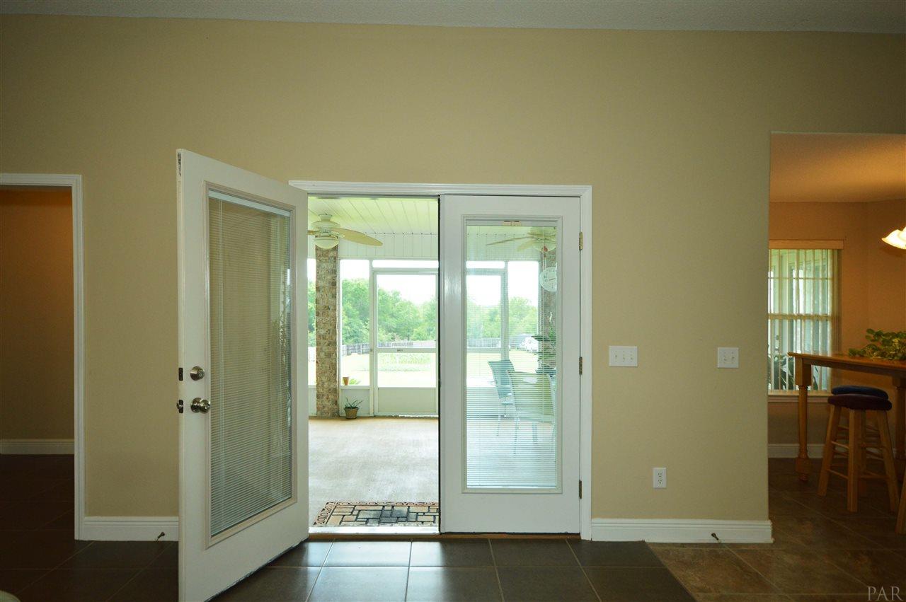 3073 Wallace Lake Road Pace, FL 32571 - Photo 23 of 48 to screened porch and backyard