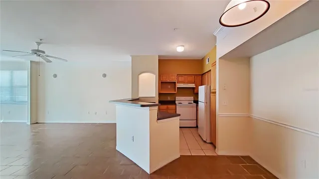 a kitchen with stainless steel appliances granite countertop a refrigerator and a stove