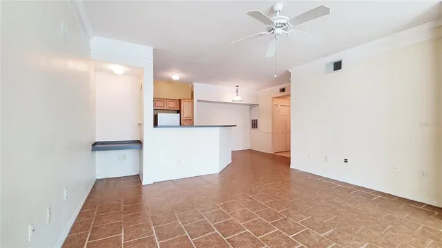 a view of a kitchen with a sink and a refrigerator