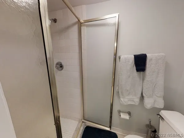 a bathroom with a double vanity sink toilet and shower