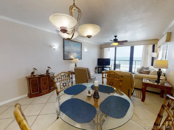 a kitchen with a sink a stove and chairs with wooden floor