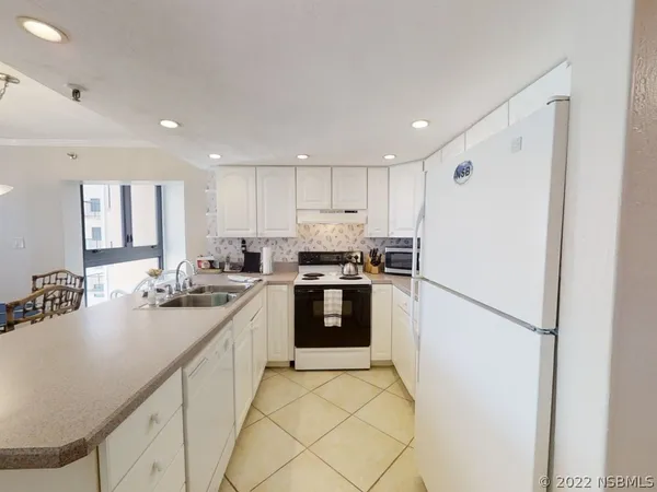 a kitchen with a stove and a white cabinets