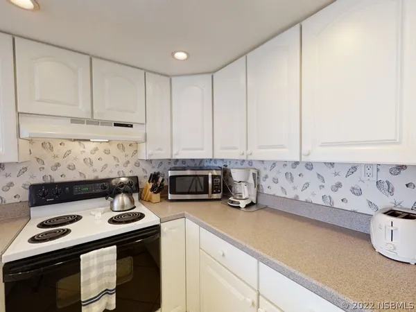 a kitchen with a sink cabinets and window