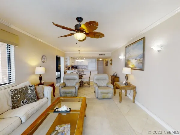 a kitchen with granite countertop a dining table chairs and a chandelier