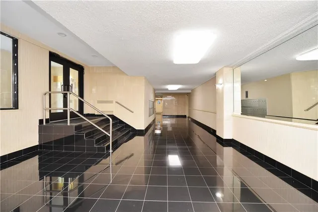 a lobby with a chandelier and rug