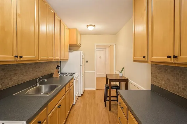 a kitchen with sink cabinets and wooden floor