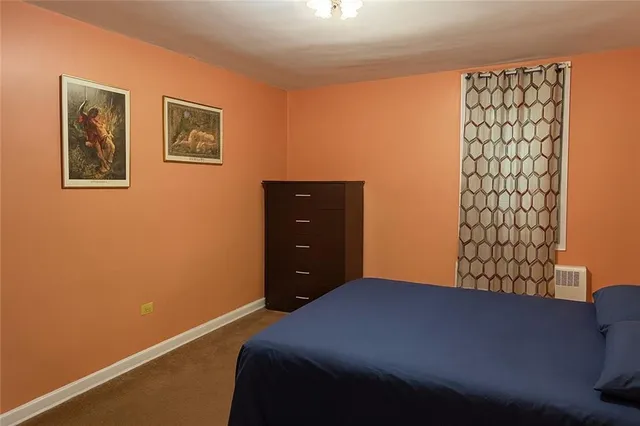 a bedroom with a bed and a wall painting