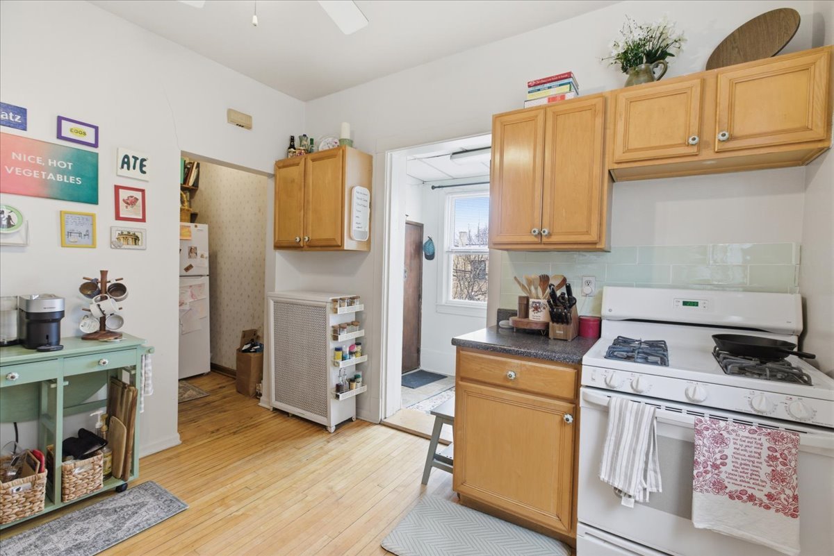 2318 West Addison Street Chicago, IL 60618 - Photo 11 of 31 a kitchen with stainless steel appliances granite countertop a refrigerator stove and sink