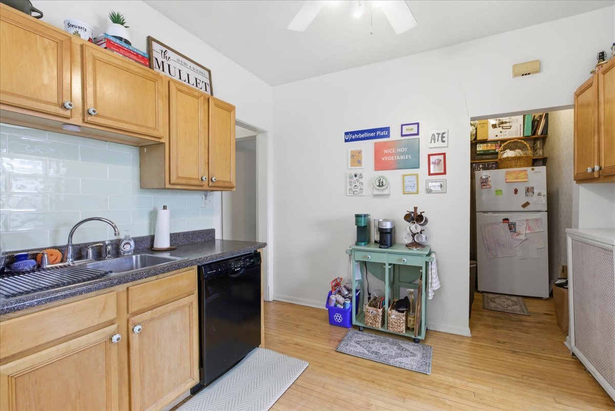 2318 West Addison Street Chicago, IL 60618 - Photo 13 of 31 a kitchen with stainless steel appliances granite countertop a refrigerator and a sink
