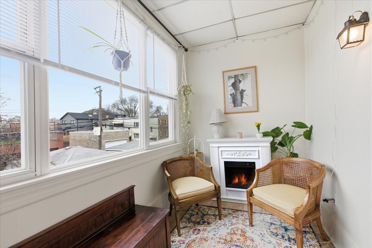 2318 West Addison Street Chicago, IL 60618 - Photo 14 of 31 a living room with furniture a window and a fireplace