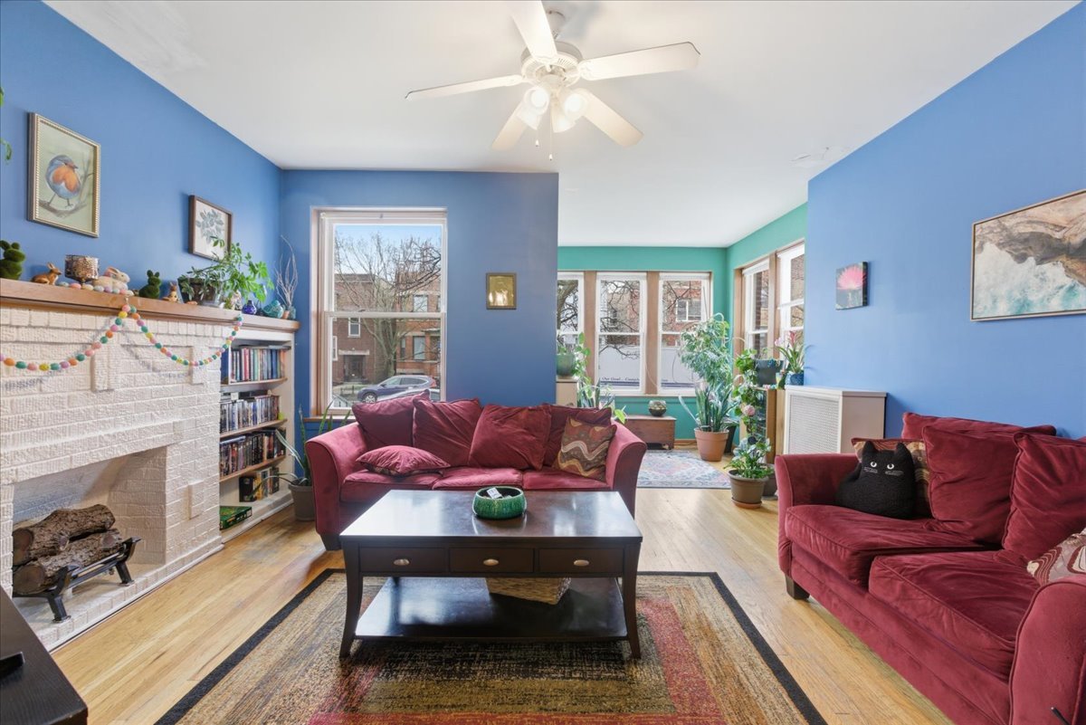 2318 West Addison Street Chicago, IL 60618 - Photo 15 of 31 a living room with furniture a fireplace and a flat screen tv