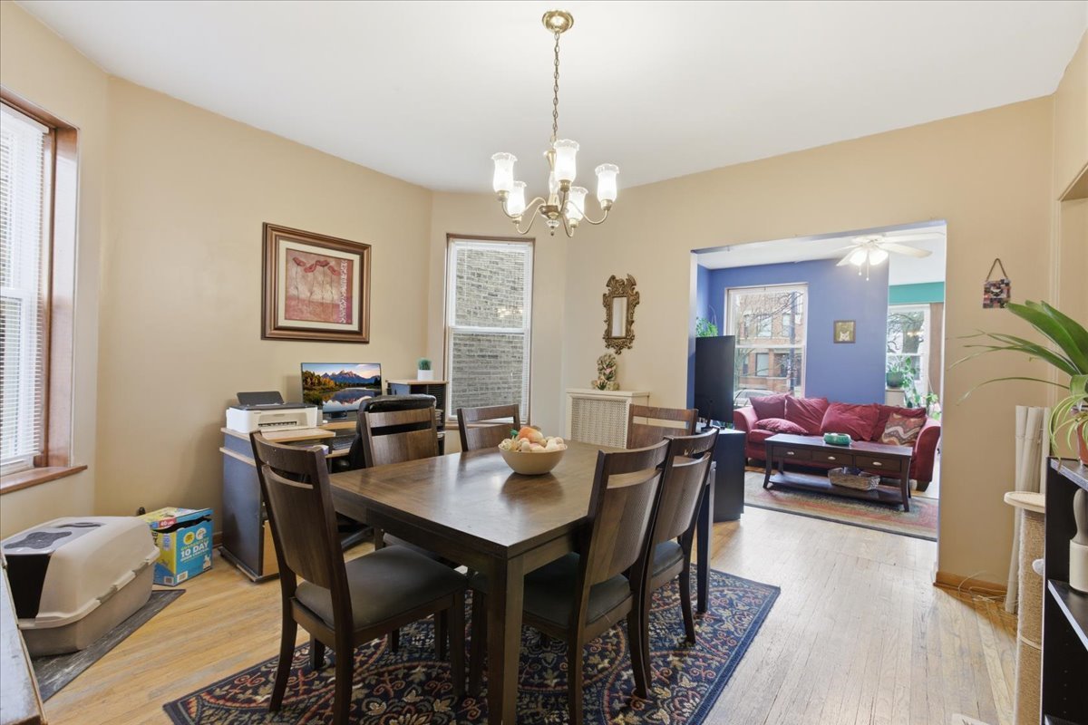 2318 West Addison Street Chicago, IL 60618 - Photo 18 of 31 a view of a dining room with furniture and a chandelier