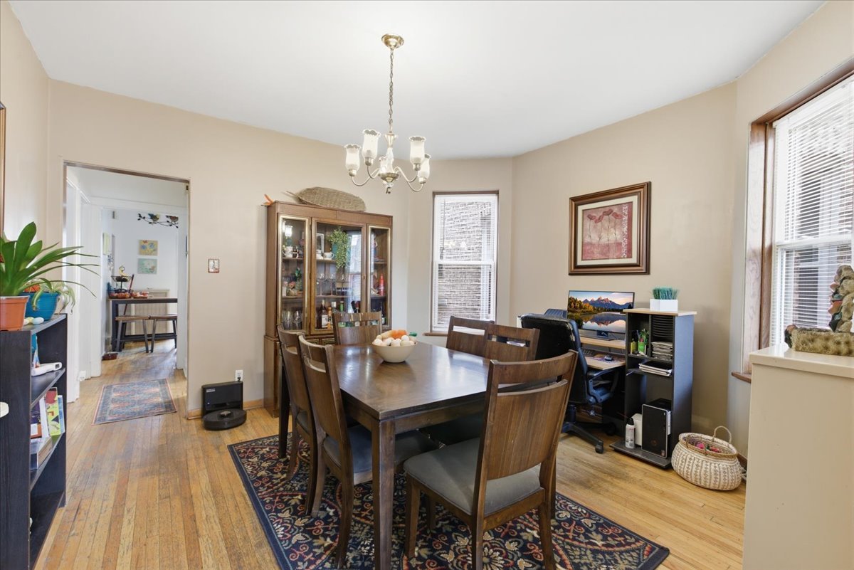 2318 West Addison Street Chicago, IL 60618 - Photo 19 of 31 a view of a dining room with furniture window and wooden floor