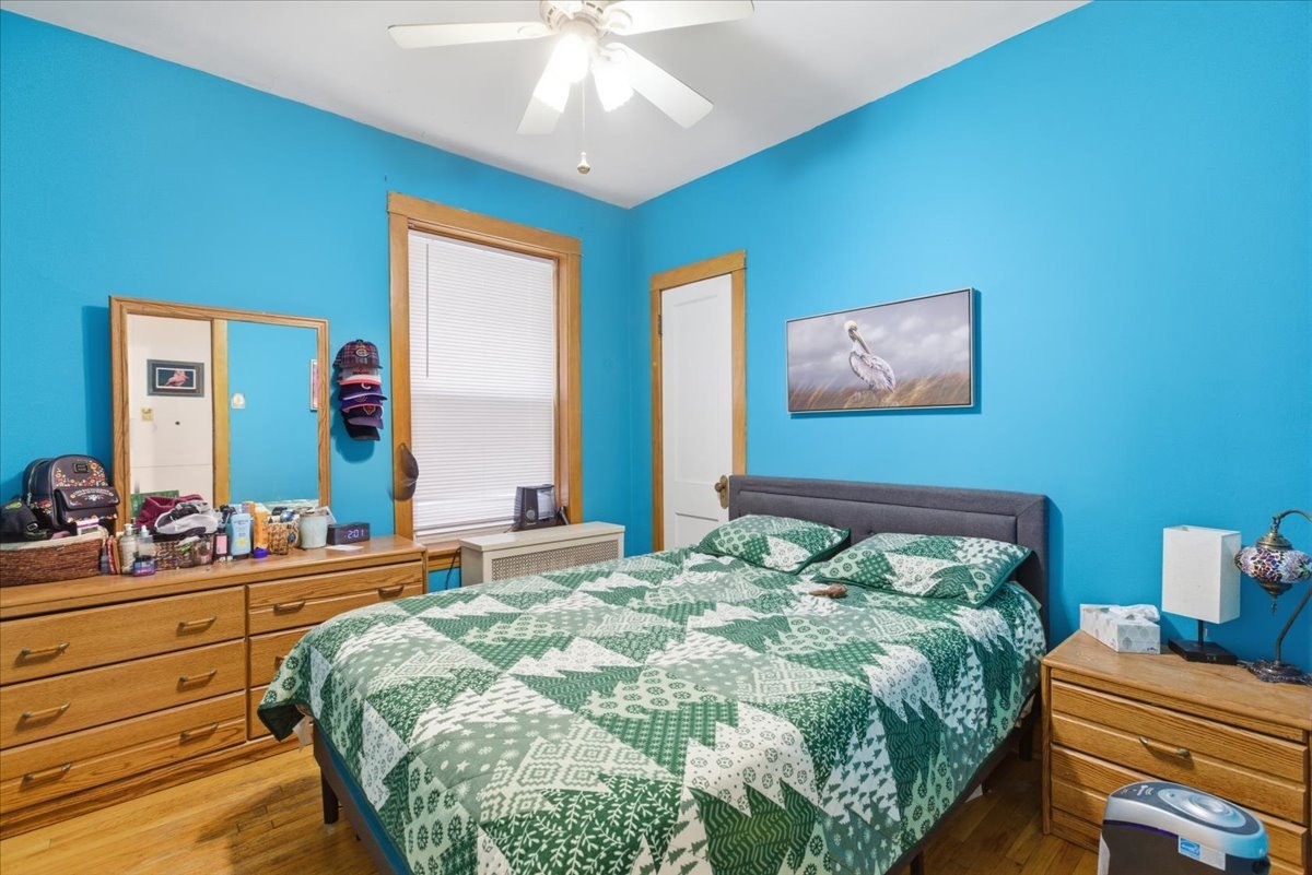 2318 West Addison Street Chicago, IL 60618 - Photo 20 of 31 a bedroom with a bed and a chandelier