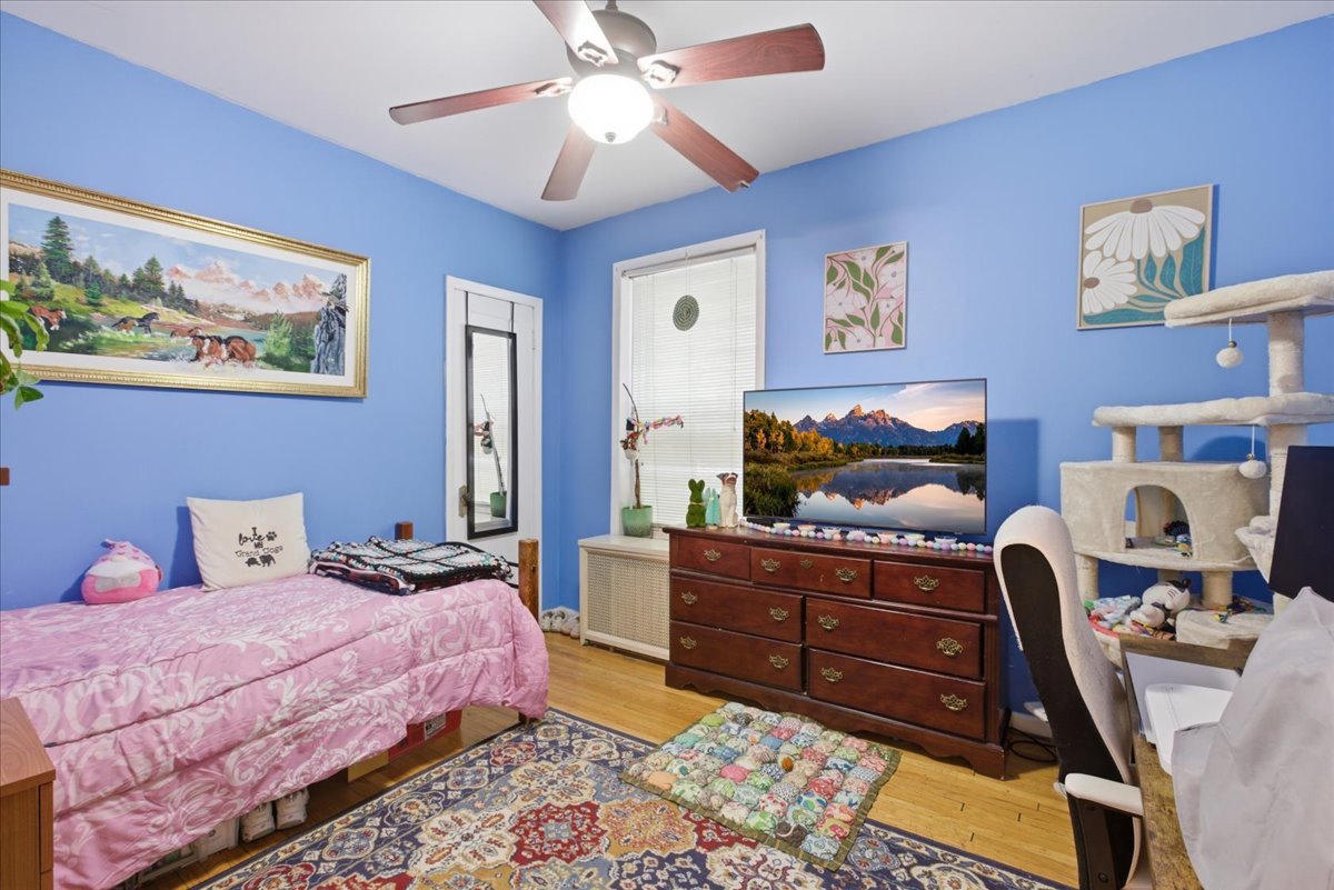 2318 West Addison Street Chicago, IL 60618 - Photo 21 of 31 a bedroom with a bed and wooden floor