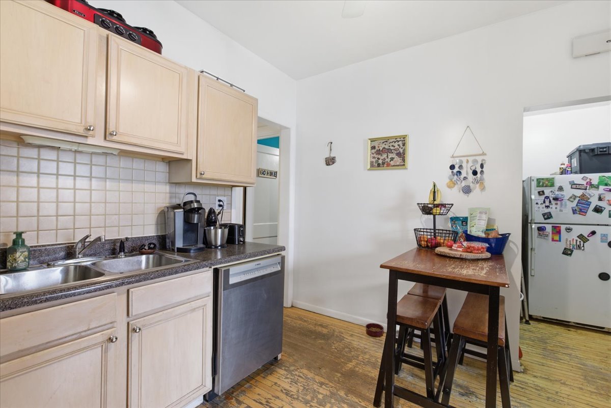 2318 West Addison Street Chicago, IL 60618 - Photo 24 of 31 a kitchen with stainless steel appliances kitchen island granite countertop a sink cabinets and window