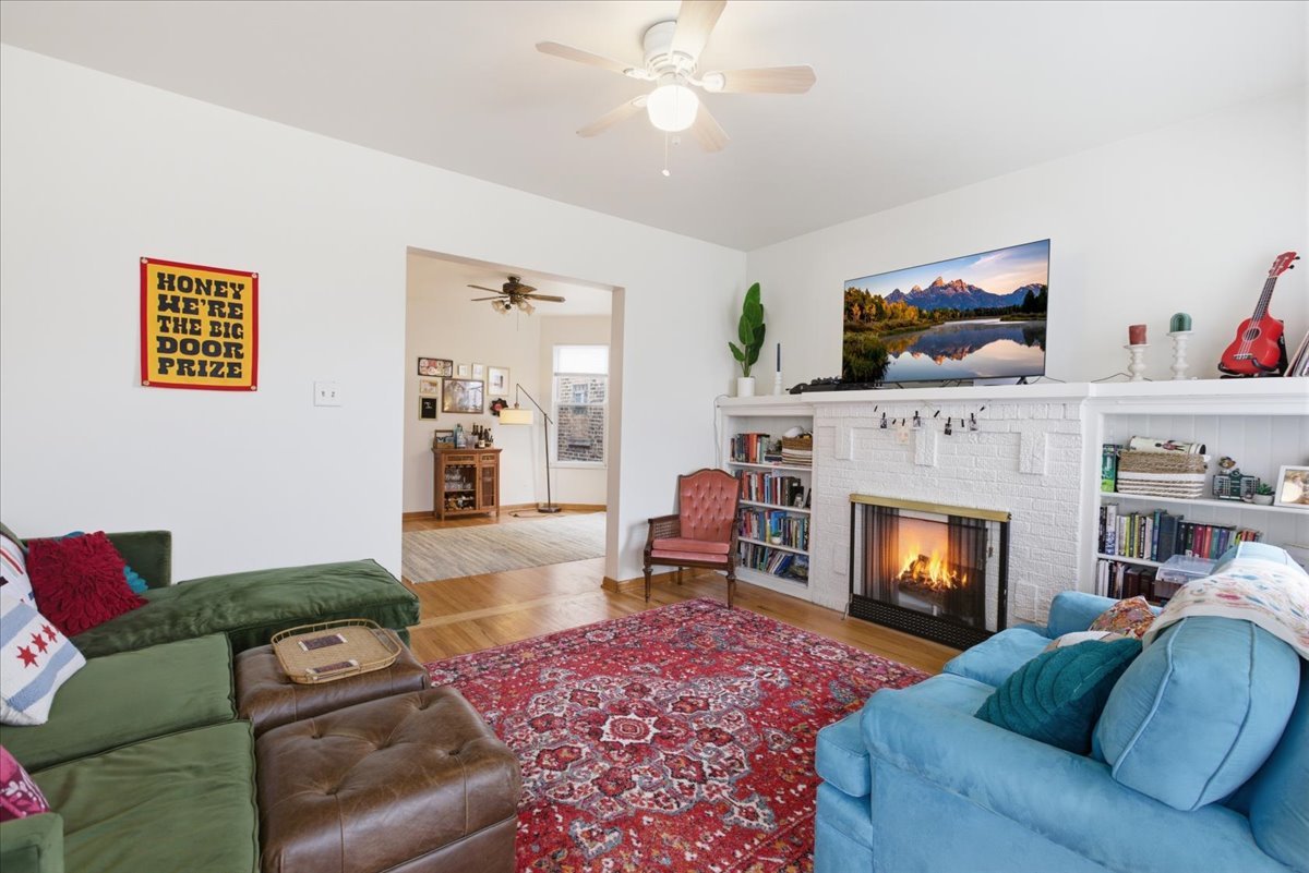 2318 West Addison Street Chicago, IL 60618 - Photo 3 of 31 a living room with furniture and a fireplace