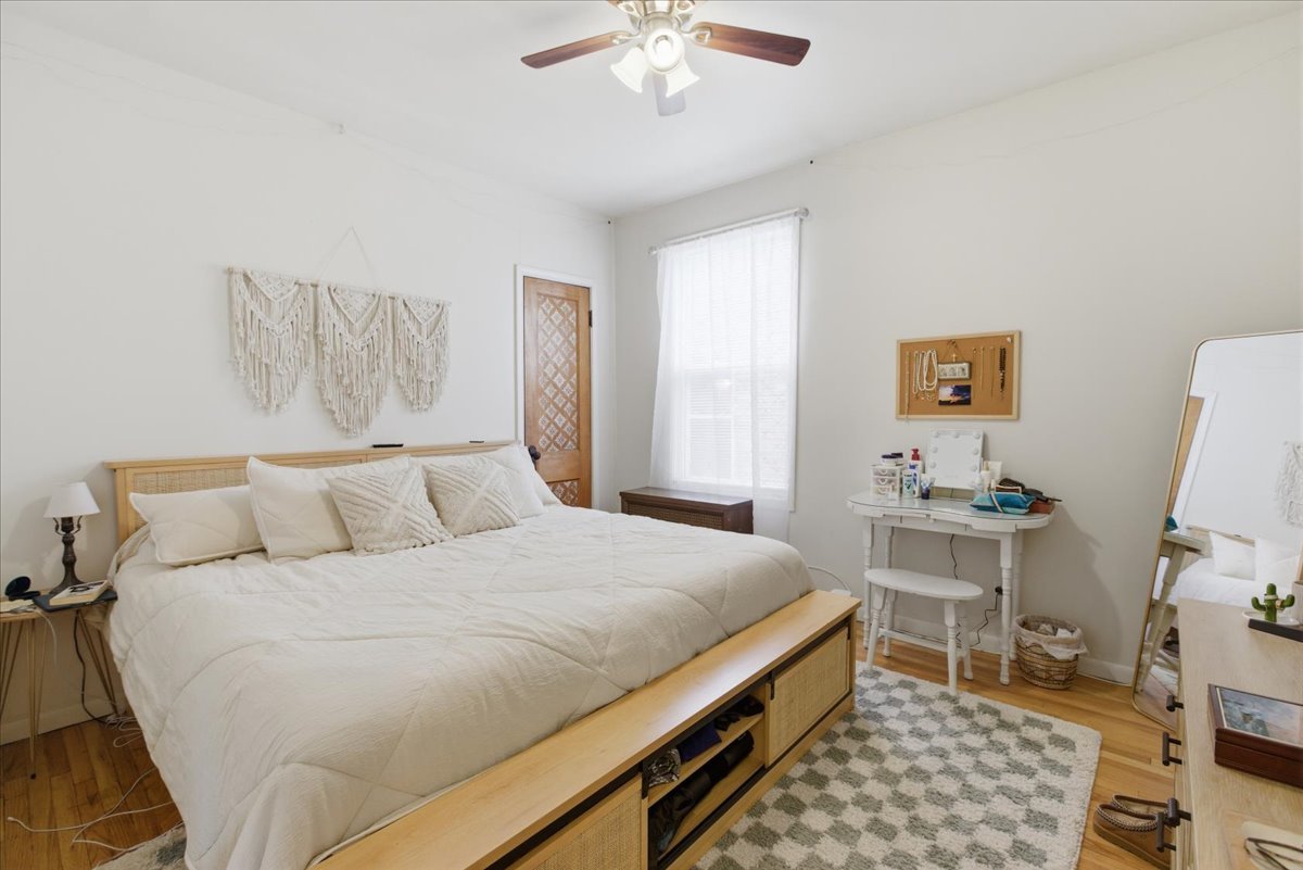 2318 West Addison Street Chicago, IL 60618 - Photo 7 of 31 a bedroom with a bed and a chandelier