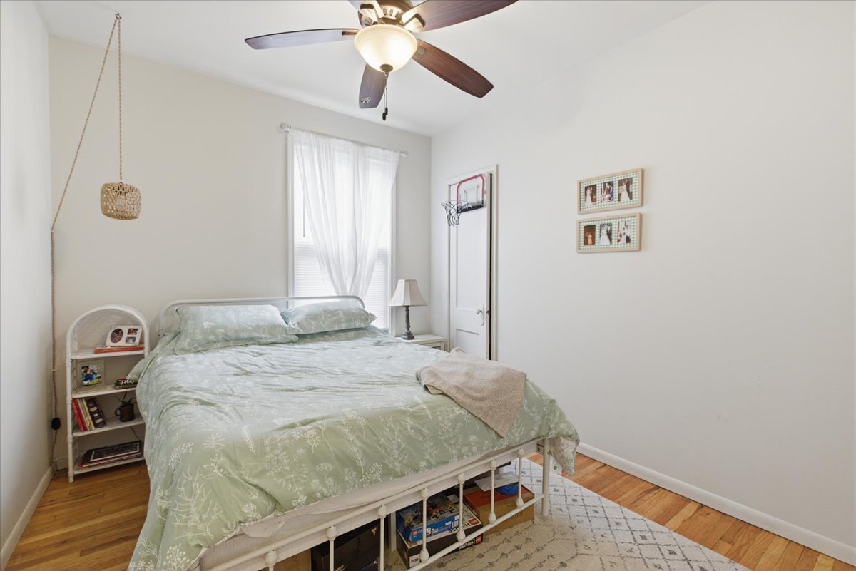 2318 West Addison Street Chicago, IL 60618 - Photo 8 of 31 a bedroom with a bed a dresser and potted plants