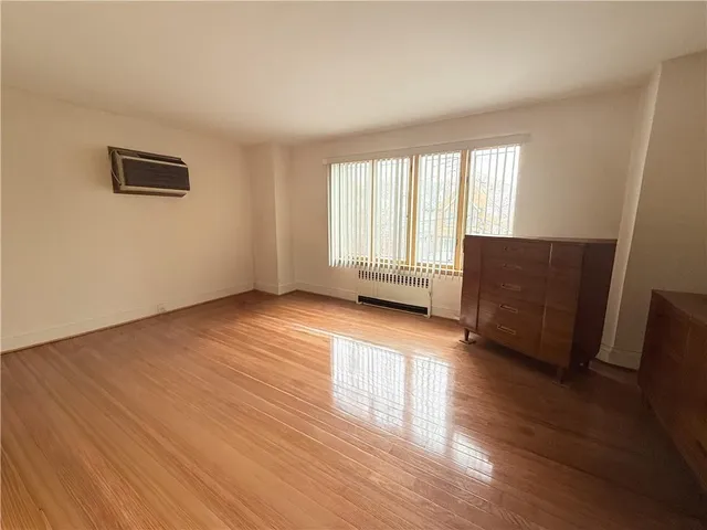 a living room with hard wood floors and a window