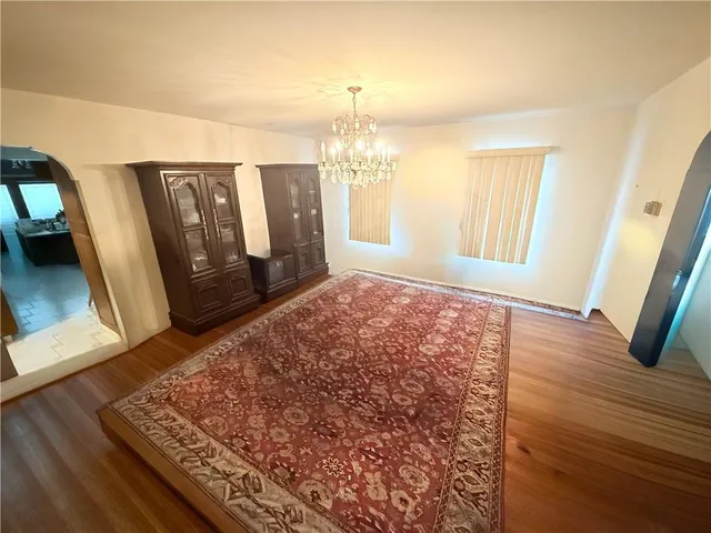 a view of a big room with chandelier and closet