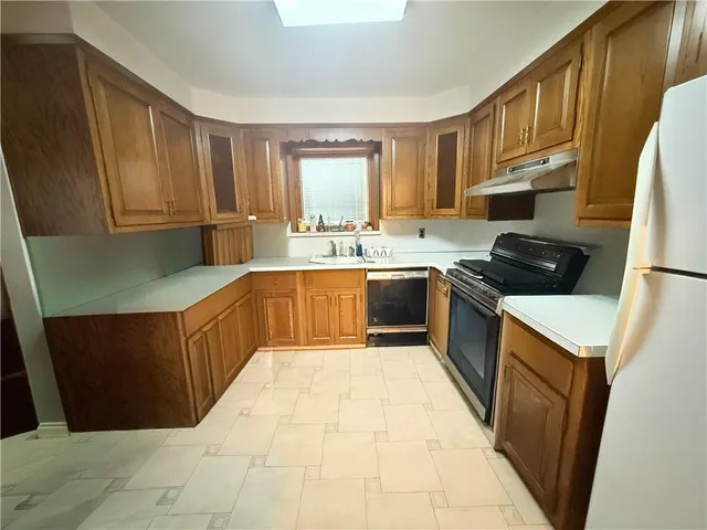 a kitchen with refrigerator and window
