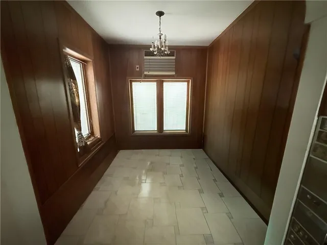 a large white kitchen with cabinets and wooden floor