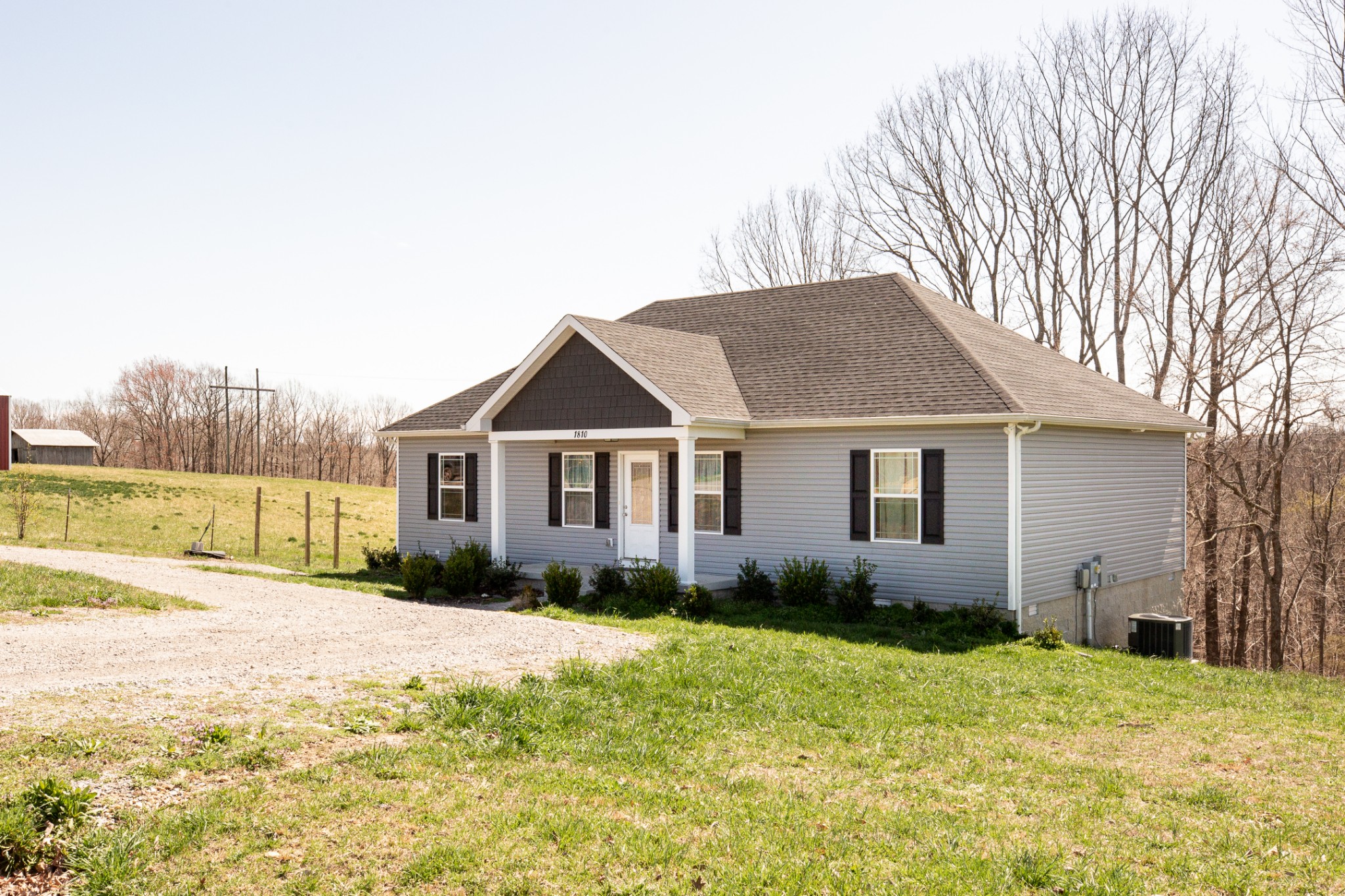1810 Holland Road Lafayette, TN 37083 - Photo 2 of 10 a front view of house with yard and trees around