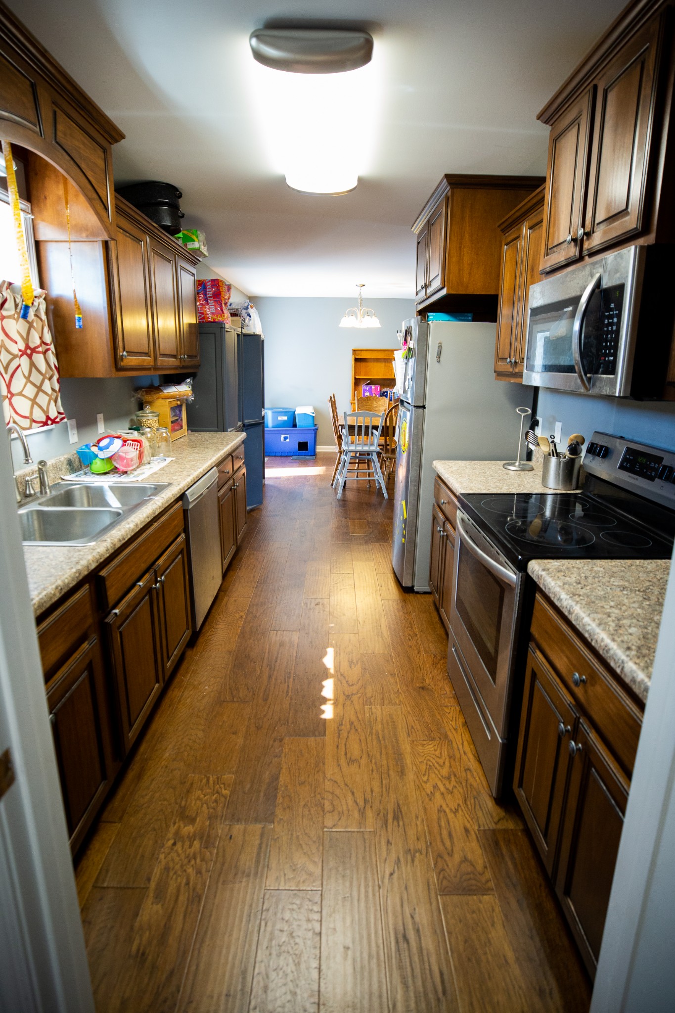 1810 Holland Road Lafayette, TN 37083 - Photo 5 of 10 a kitchen with kitchen island granite countertop a sink stove and refrigerator