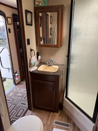 a bathroom with a sink toilet and shower
