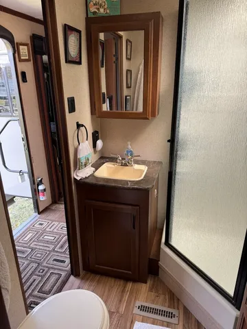 a bathroom with a sink toilet and shower