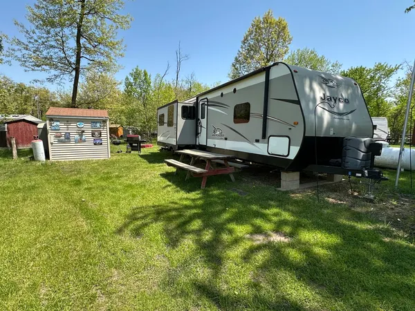 a backyard of a house with table and chairs