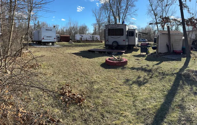 a view of a backyard with table and chairs