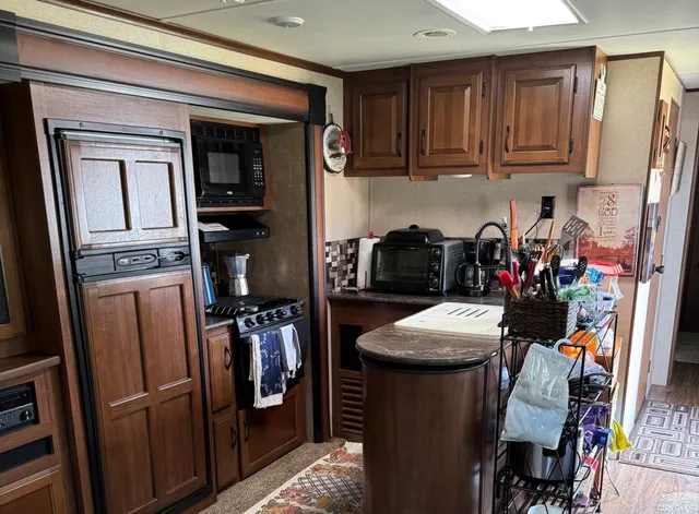 a kitchen with stainless steel appliances granite countertop a refrigerator and a sink