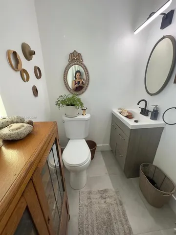 a bathroom with a toilet sink and mirror
