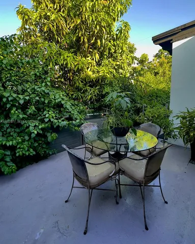 a backyard of a house with table and chairs