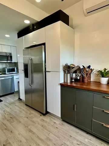 a kitchen with stainless steel appliances a refrigerator and wooden cabinets