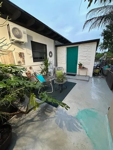 a view of a patio with table and chairs under an umbrella