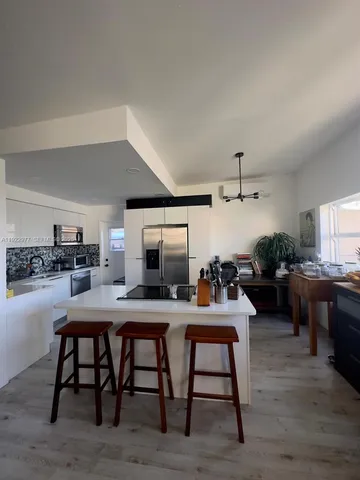 a view of a dining room kitchen with furniture and wooden floor